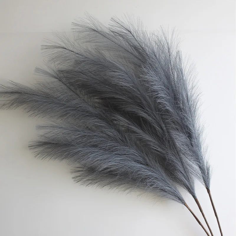 A bunch of gray artificial pampas grass branches used for boho home and wedding decor.