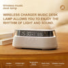 A white wireless charger music desk lamp with a digital display is shown on a wooden surface.