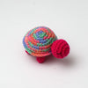 Handmade crocheted turtle plush toy with multicolored body and pink feet