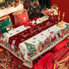 A festive red Christmas table setting featuring a tablecloth with snowflakes and holiday decorations.