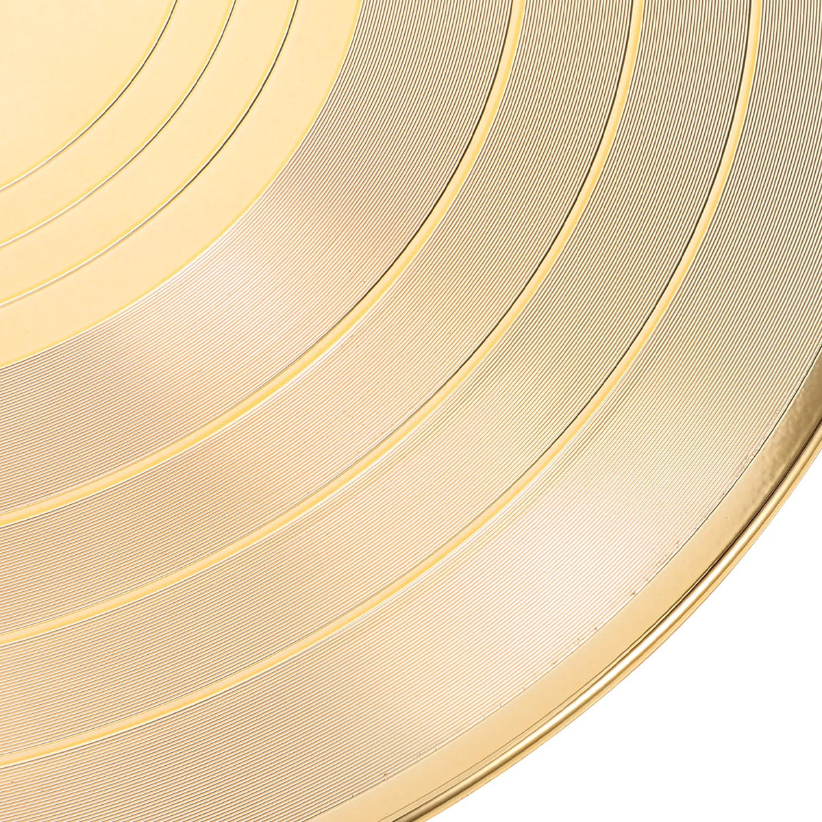 A close-up of a gold vinyl record wall clock featuring concentric circular grooves.