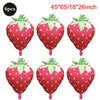 Six pink strawberry foil balloons with green leaves and white dots for party decorations
