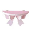 A pink decorative bow-shaped wooden wall shelf.