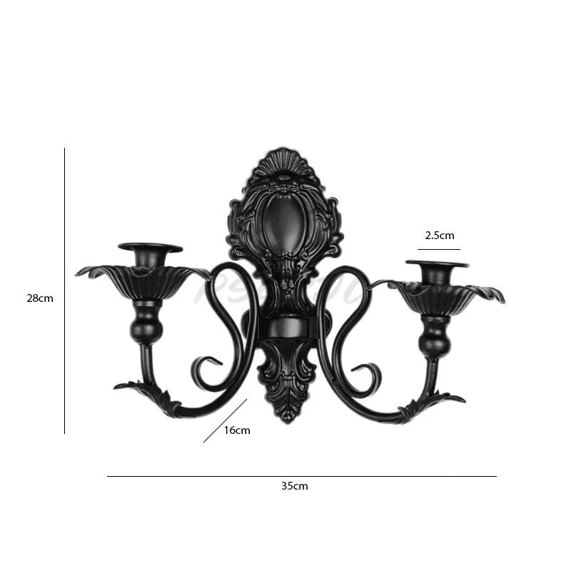Vintage black wall pendant candle holder with ornate metalwork and decorative arms