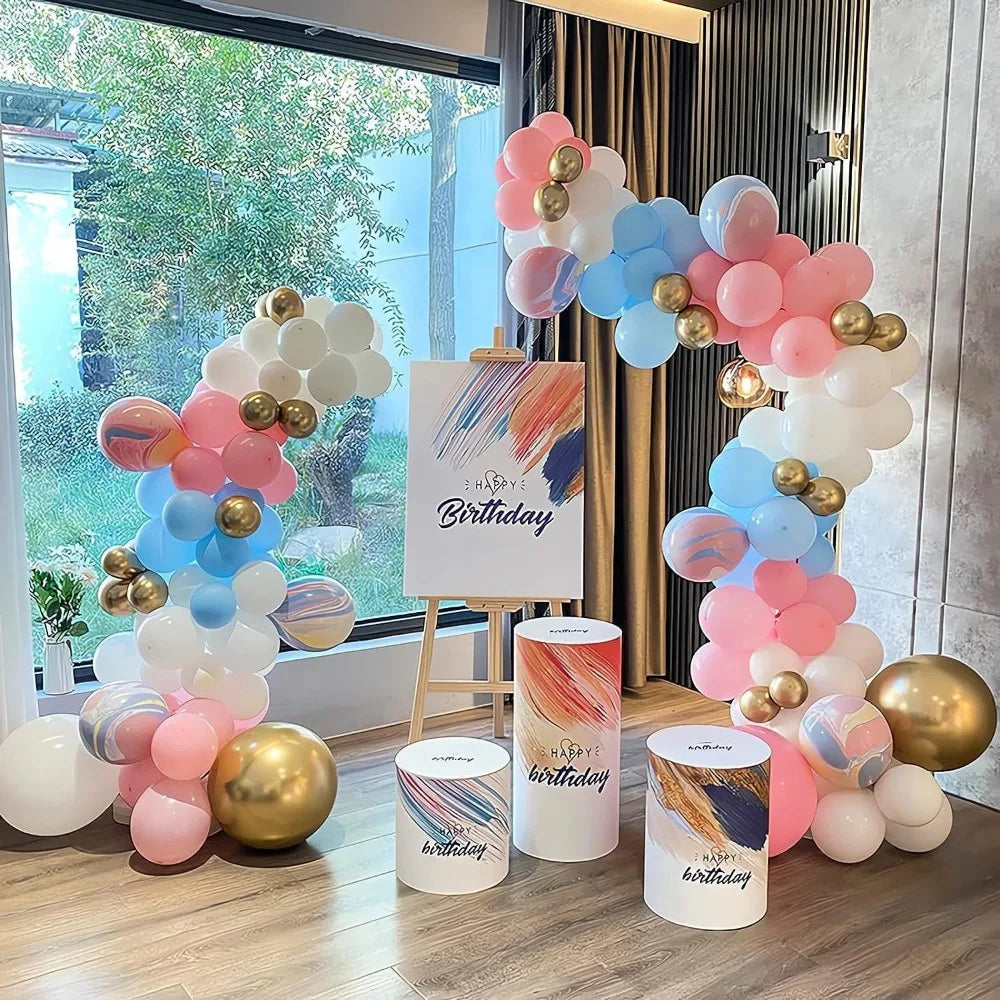A balloon arch display featuring pink, blue, and white balloons arranged in a tiered structure.