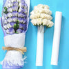 White foam flower arrangement cylinder for wedding centerpieces wrapped in purple tissue paper