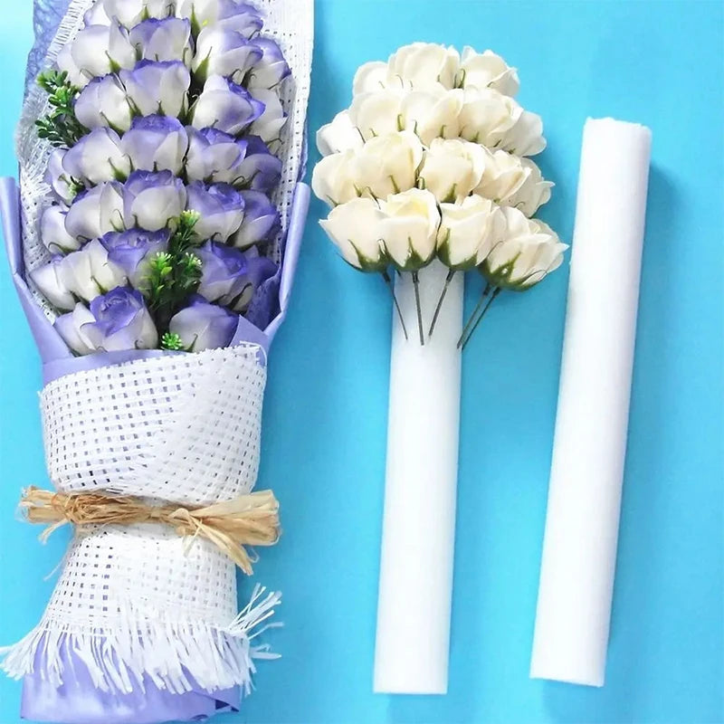 White foam flower arrangement cylinder for wedding centerpieces wrapped in purple tissue paper