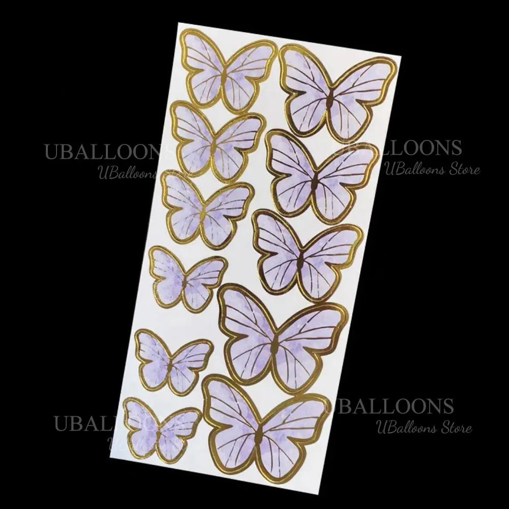 A set of eleven gold, pink, and purple 3D butterfly cake toppers.