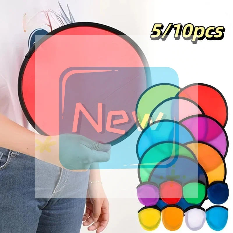 A collection of colorful, translucent, foldable cooling fans and flying discs are displayed against a white background.