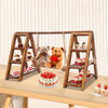 A three-tier solid wood dessert display stand featuring hanging racks for showcasing cupcakes and desserts.