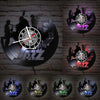 A set of vintage vinyl record wall clocks featuring silhouettes and musical notes on a distressed brick background.