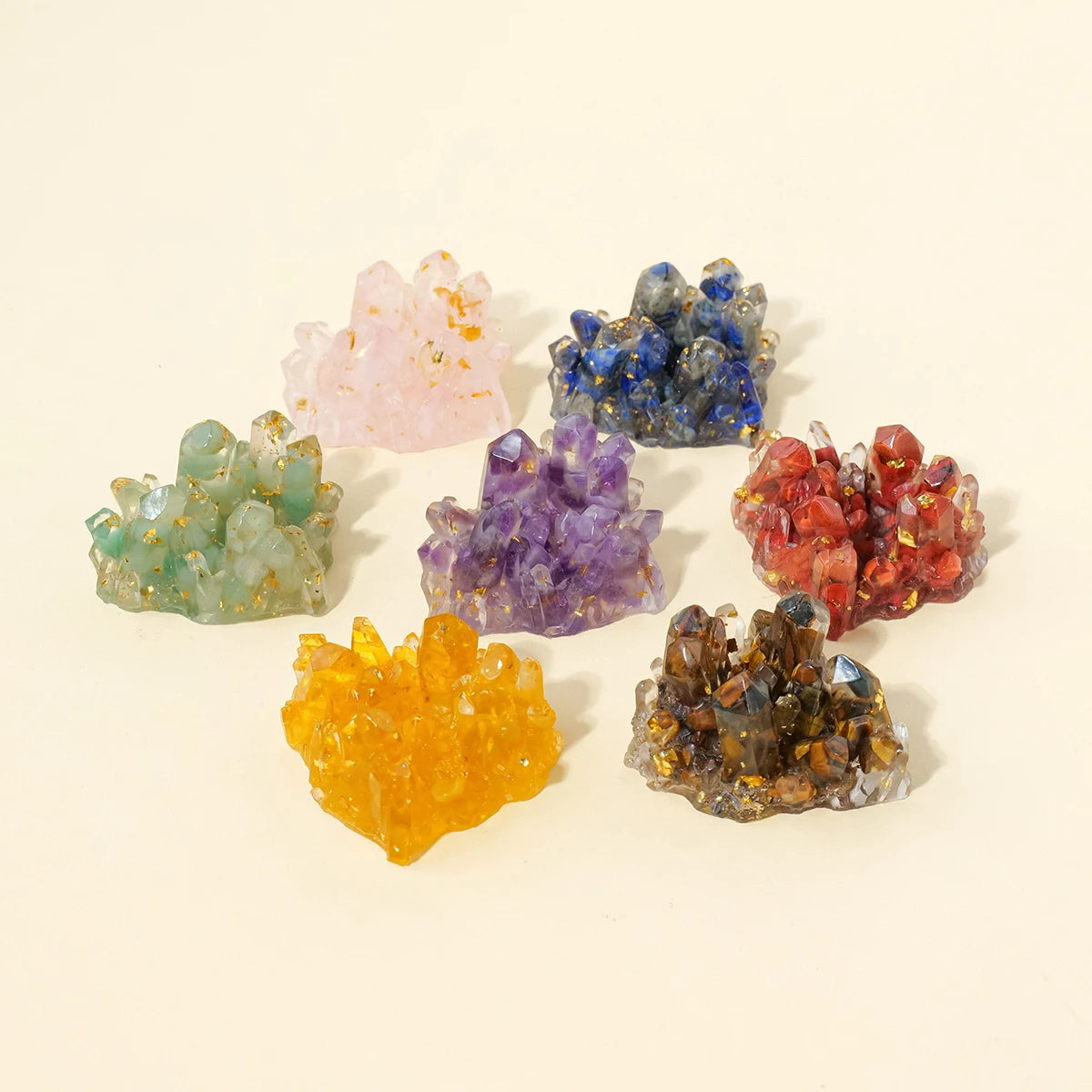 A collection of colorful natural crystal stone clusters in pink, blue, purple, and orange hues.