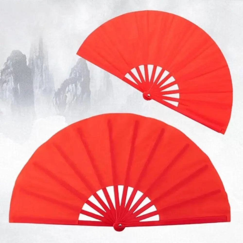 A bright red Tai Chi performance fan with durable plastic ribs shown in a half-open angle against a snowy background.