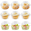 Clear plastic packaging boxes containing various baked goods including muffins and fresh fruit salads