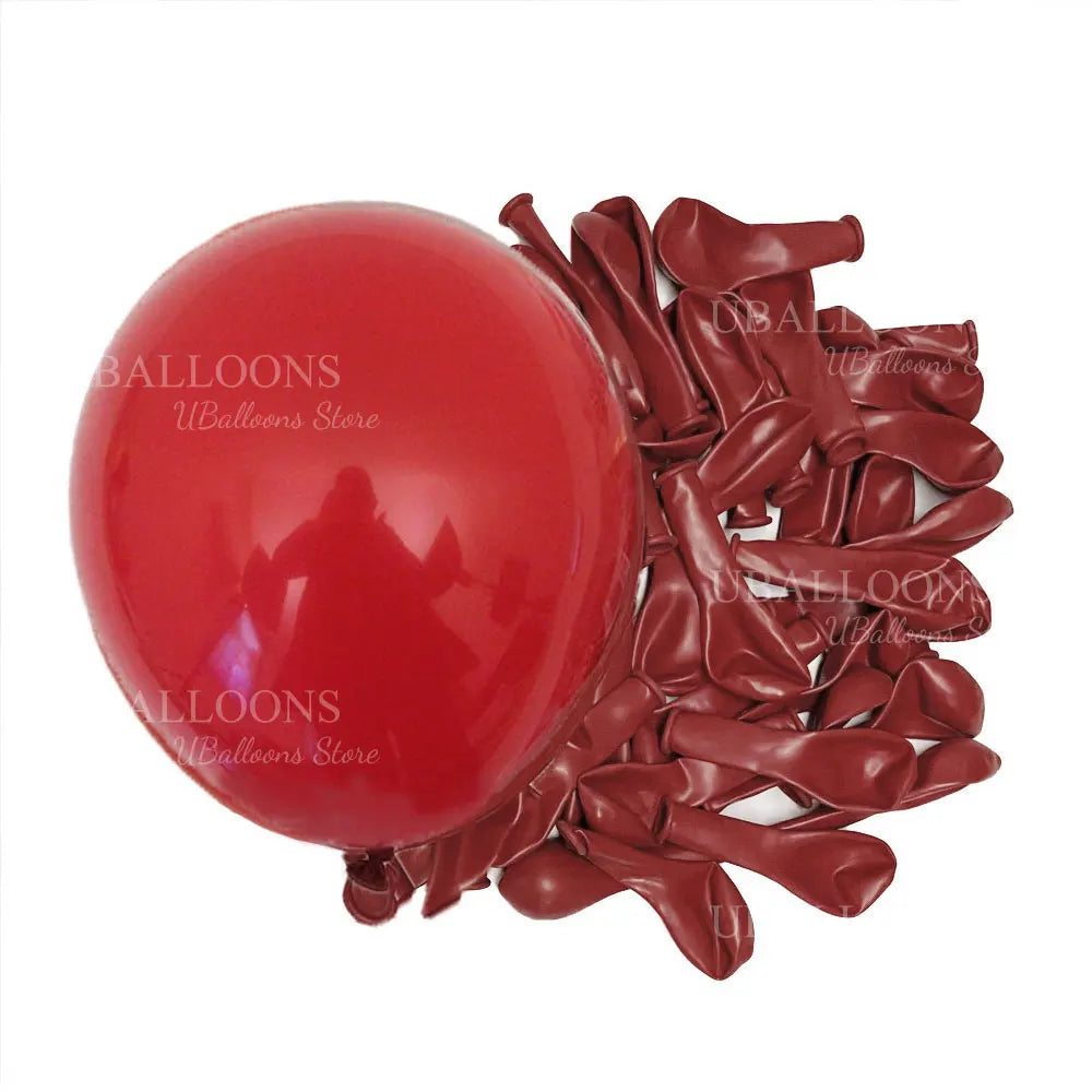 A cluster of deep burgundy latex balloons is shown against a white background.