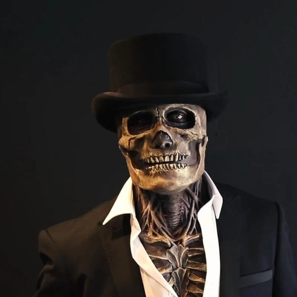 A realistic latex full face skull mask with a top hat displayed against a dark background.