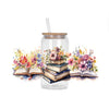 A glass jar filled with flowers and stacked books, featuring a straw and decorative stickers.