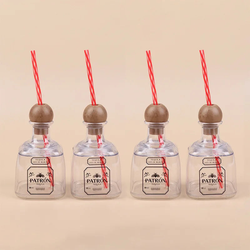 Four clear plastic drinking bottles with wooden stoppers and red straws, labeled Patron tequila.