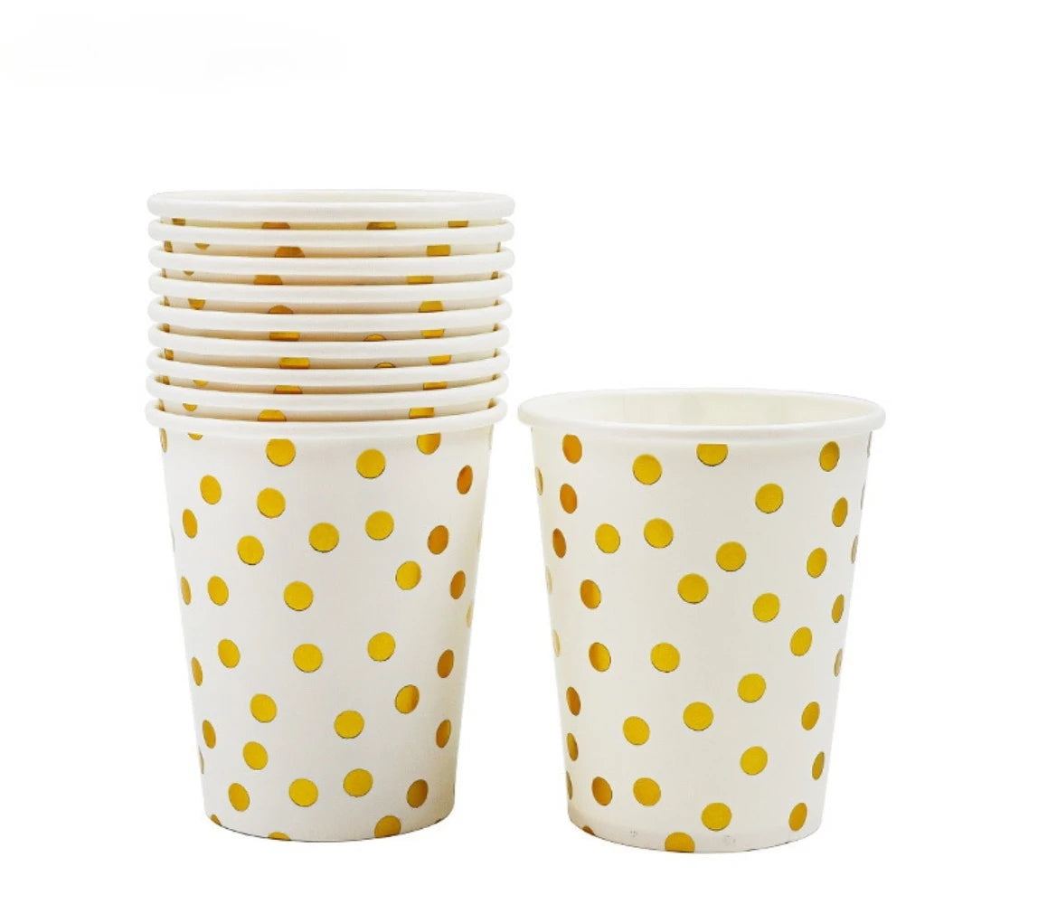 A set of white disposable cups with yellow polka dots.