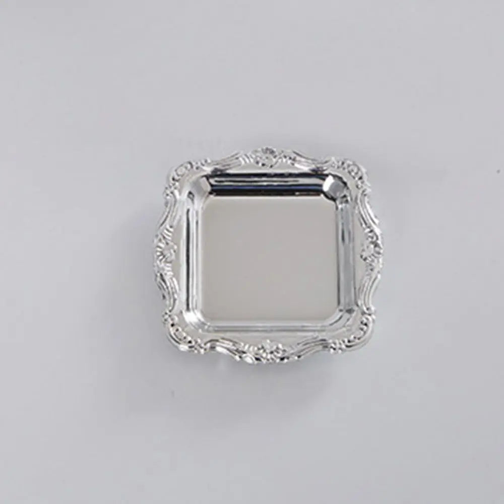 A silver-toned mirror-finish mini tray with an ornate, scalloped edge.