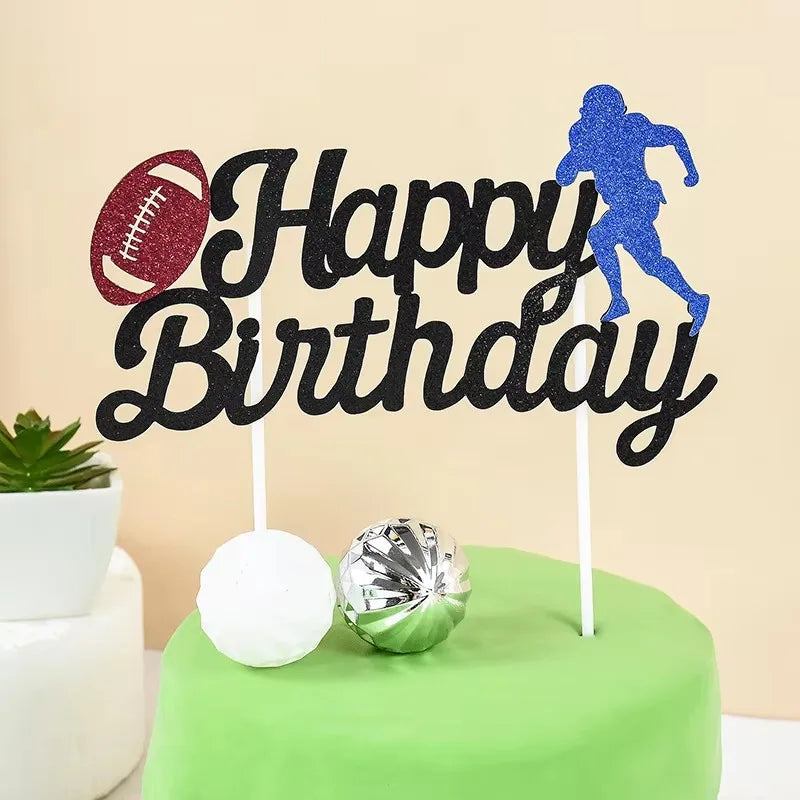 Black birthday cake toppers featuring a soccer player silhouette and a football on a green cake.