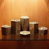 A display of wooden hexagonal racks holding various pieces of jewelry and accessories on a glass surface.