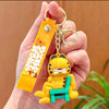 A yellow Garfield cartoon character keychain pendant with a gold ring attached to a yellow tag.