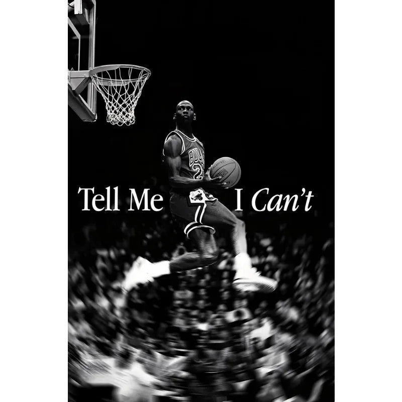 Black and white photo of a basketball player in mid-air during a game, emphasizing movement and athletic focus.