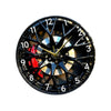 A close-up view of a black and gold creative 2D tire wheel acrylic wall clock face.