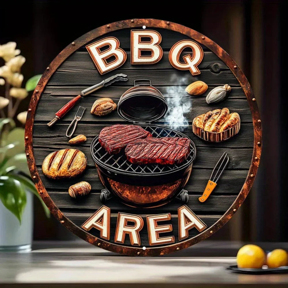 Panneau en bois rond décoré d'initiales BBQ et du mot AREA, avec divers outils de grillade et viandes.