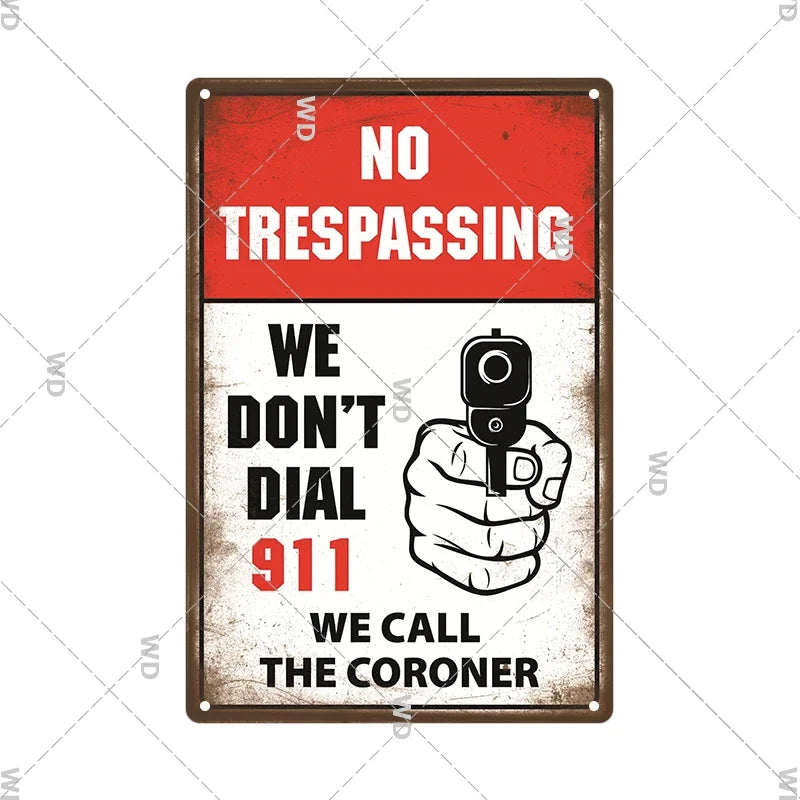 A vintage metal warning sign with a distressed red background and white text stating No Trespassing and We Don't Dial 911 We 