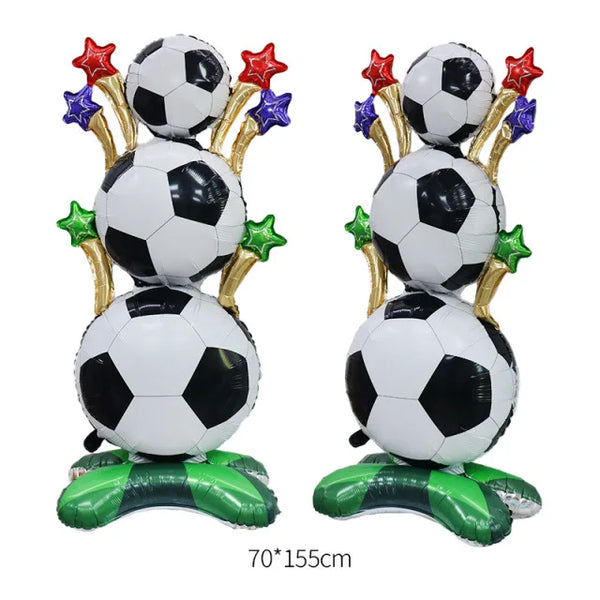 A standing foil trophy balloon featuring soccer balls and gold accents for a party decoration.