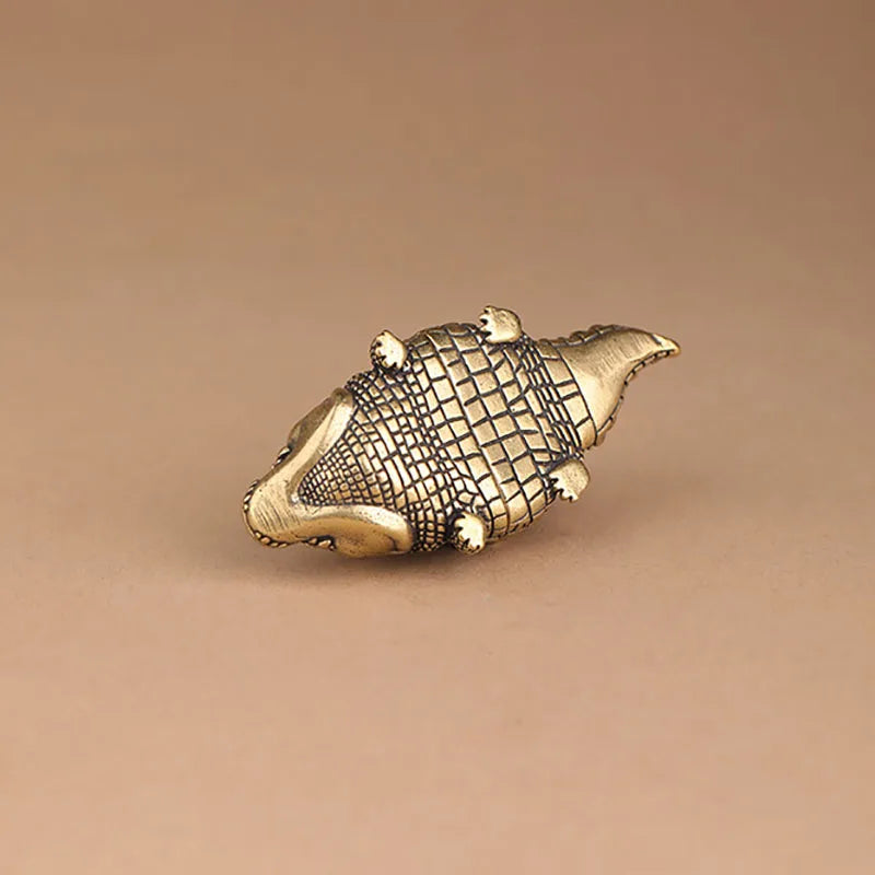 Antique brass crocodile figurine with textured scales, vintage desk decor.