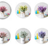 Three arrangements of romantic lavender artificial flowers in white vases with yellow and blue glass accents.