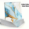 A set of marble peel-and-stick wall panels featuring blue and gold veining on a white background.