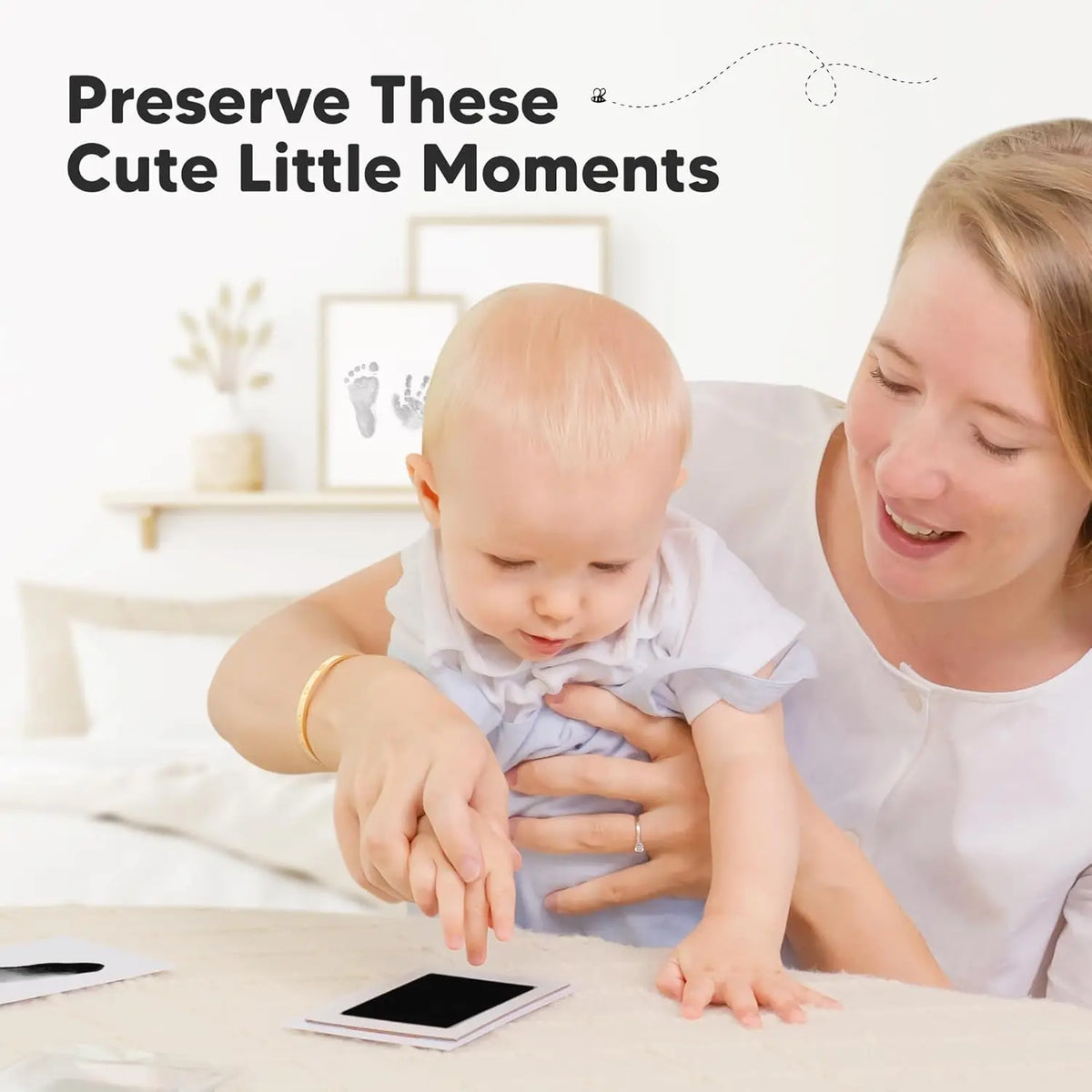 A woman gently holds a baby's hand and footprint on a surface, preserving a cute little moment.