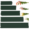 Several strips of dark green artificial flower stems and a sprig of pink flowers on a white background.