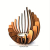 A wooden lotus candle holder decoration with curved slats and a central candle holder.