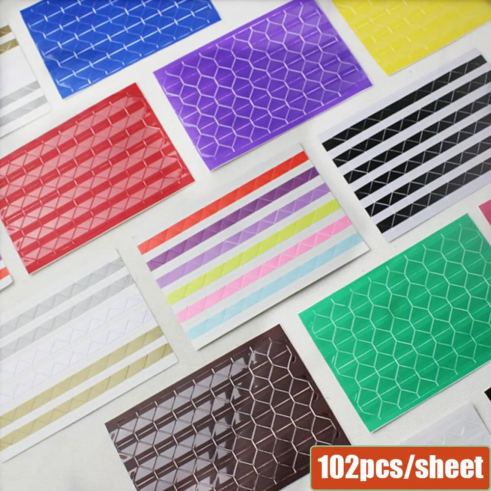 A sheet of 102 PVC photo corner protectors in various colors and patterns for scrapbooking and albums