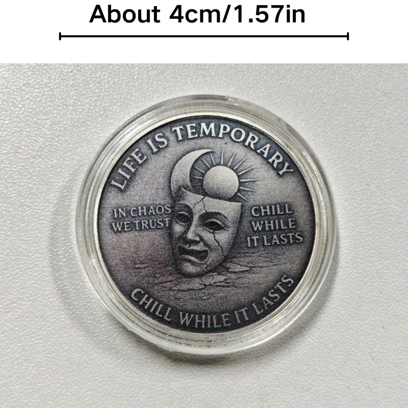 A silver challenge coin featuring a stylized skull and crow design with the text Life is temporary chill while it lasts