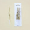 A package of twelve long, thin, gold spiral candles for parties.