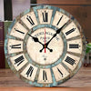 A round wooden wall clock with Roman numerals showing the time, featuring the text Paris 1979.