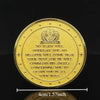 A gold medal coin featuring an emblem and text on its surface.