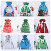 A set of five festive drawstring Christmas gift bags featuring Santa and snowman designs in blue, green, and red.