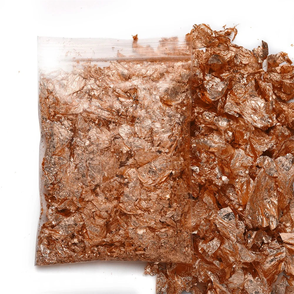 A pile of shiny gold foil flakes for resin art and jewelry making