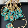 Gold-plated charm bracelet featuring turquoise beads and small framed images of the Virgin Mary Guadalupe.