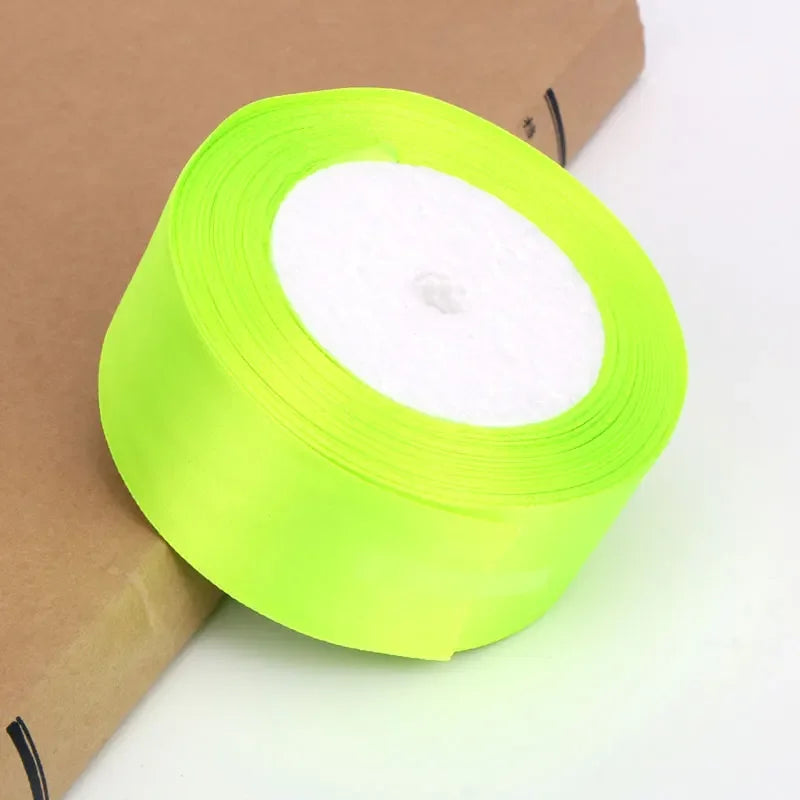 A roll of neon lime green satin ribbon for crafts and gift wrapping