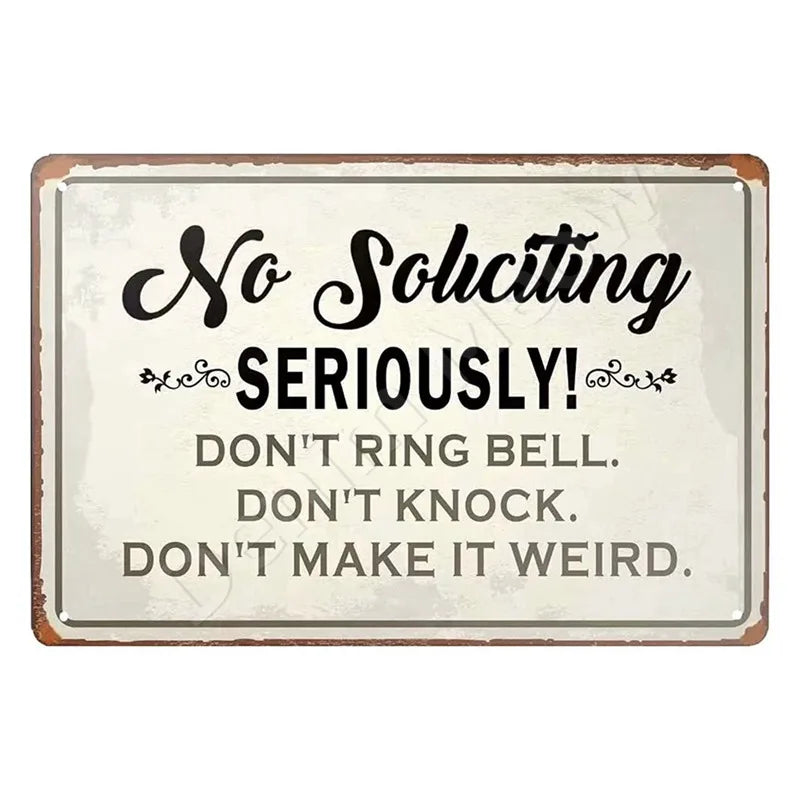 A rustic metal sign with the text No Soliciting Seriously Don't Ring Bell Don't Knock Don't Make It Weird