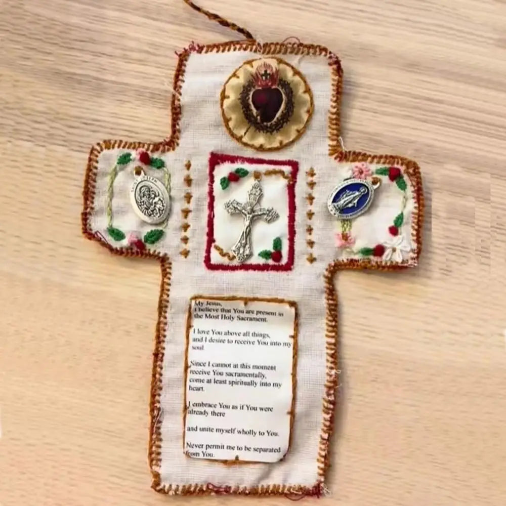 Handmade prayer quilt featuring a cross with a silver cross pocket shrine and decorative embroidery