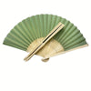 A hand-folded fan set with green pleated paper and natural wood handles.